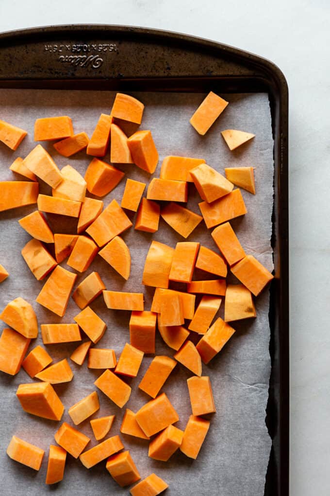 cubbed sweet potato on a baking sheet