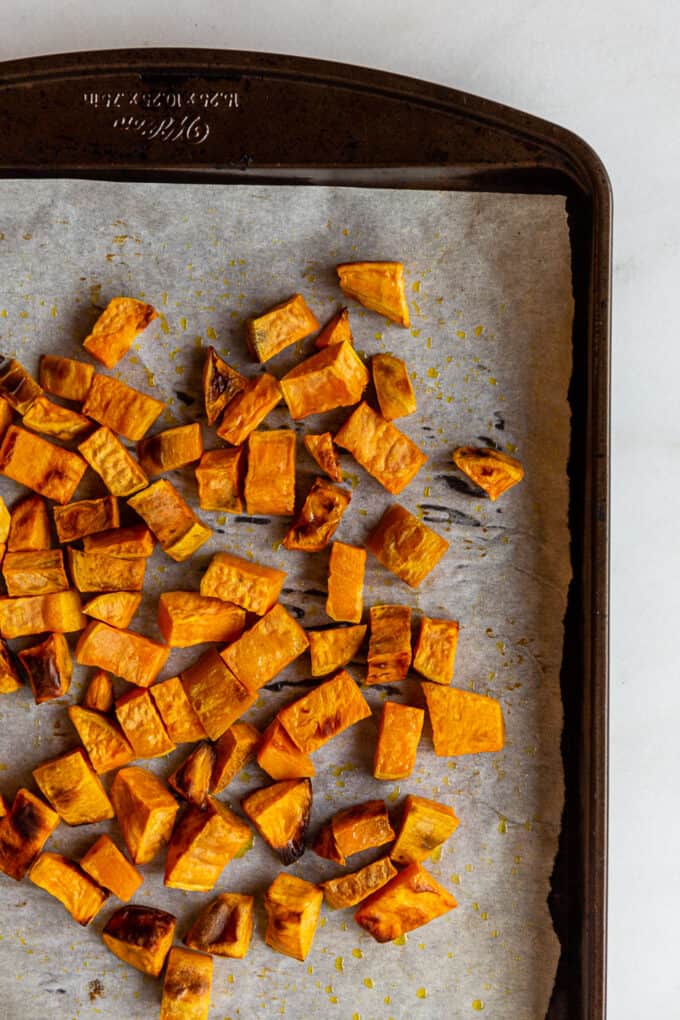 roasted cubed sweet potato on a baking sheet