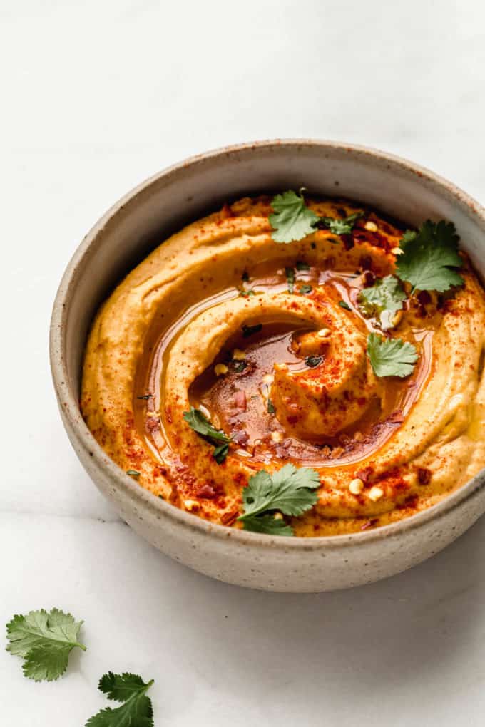 sweet potato hummus in a speckled ceramic bowl