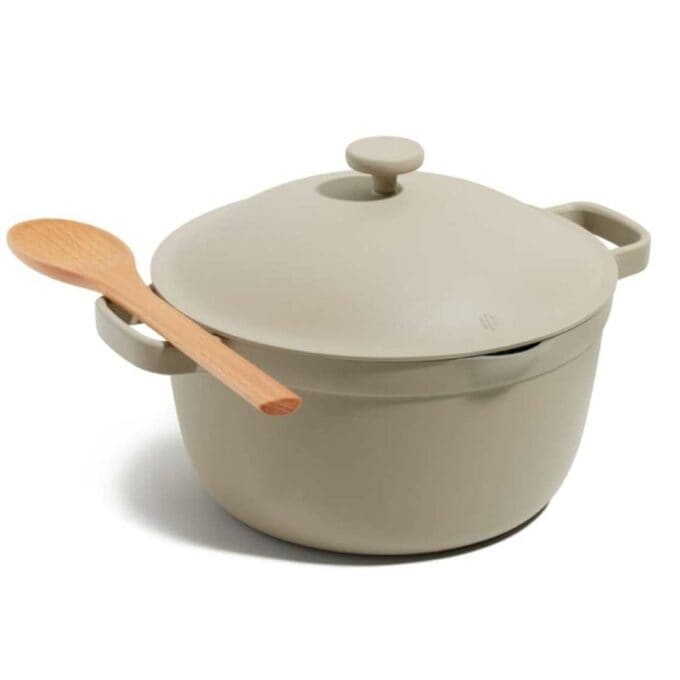 A taupe coloured pot with a wood spoon