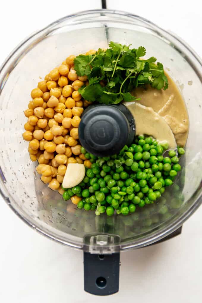 peas, chickpeas, tahini, cilantro and garlic in a food processor